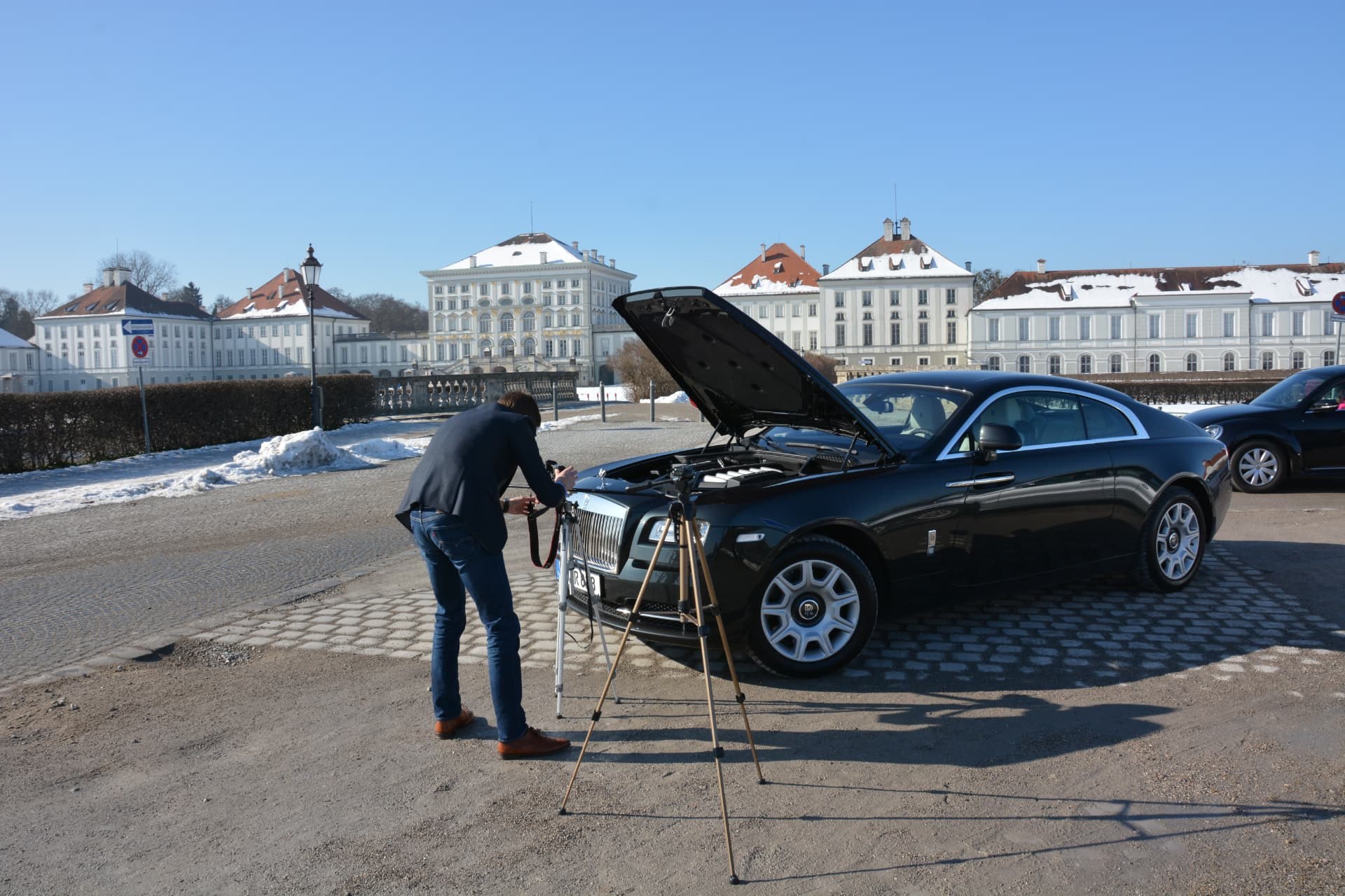 Filming a black luxury car in front of a palace in the snow